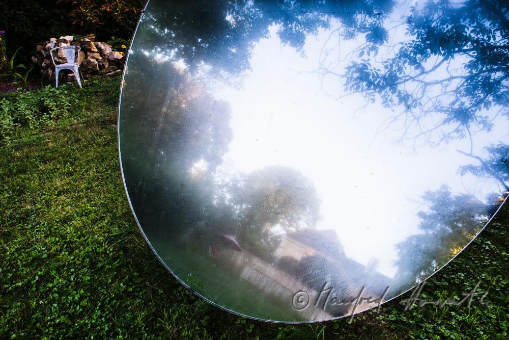 the castle reflects in the mirror (art piece) in the garden