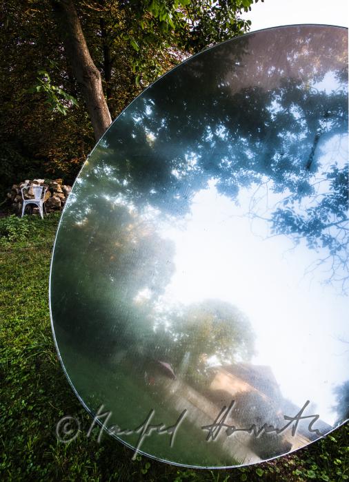 the castle reflects in the mirror (art piece) in the garden