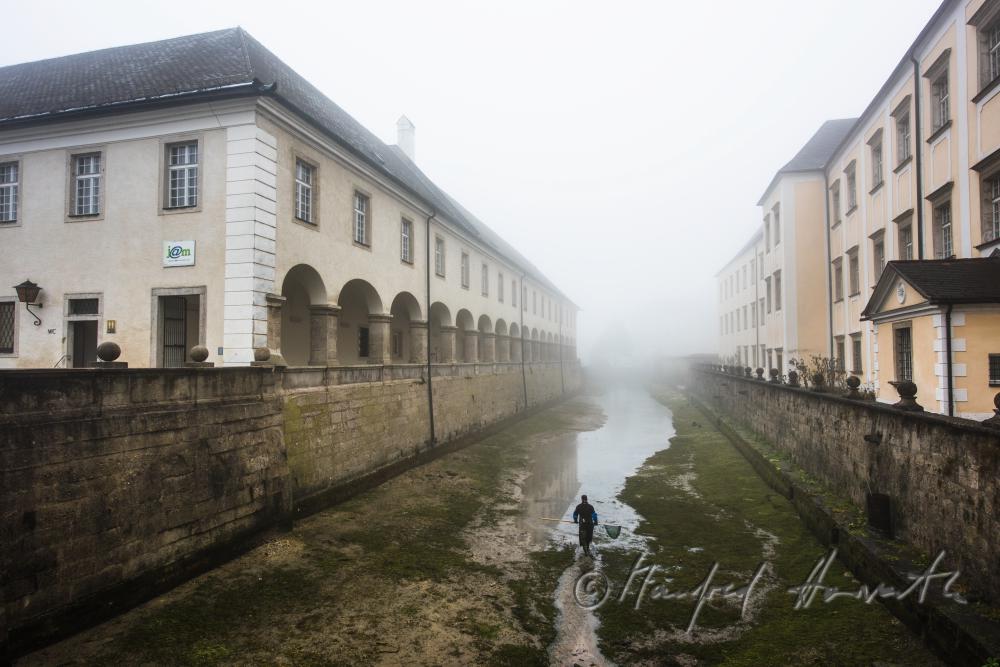 fishermen seeking for trout in the ditch of the monastery