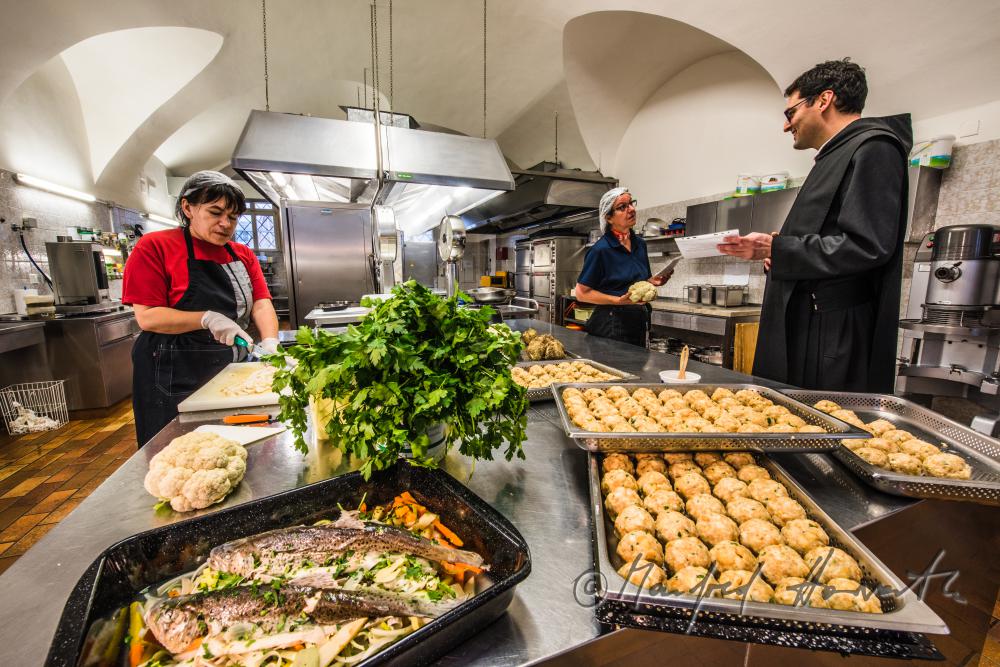 sous-chef and monks cooking in the kitchen of the monastery