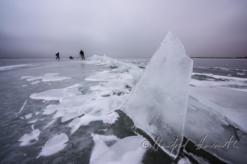 ice skaters with a slade near an ice jam