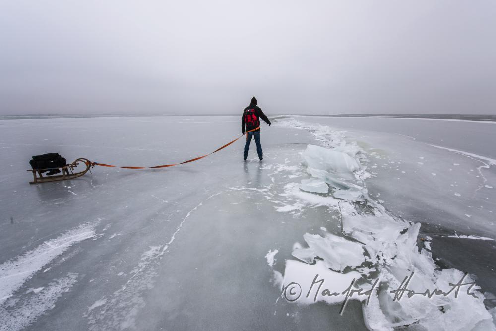 ice skaters with a slade near an ice jam