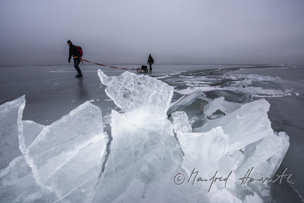 ice skaters with a slade near an ice jam