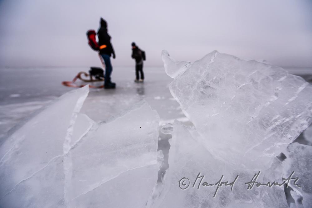 ice skaters with a slade near an ice jam