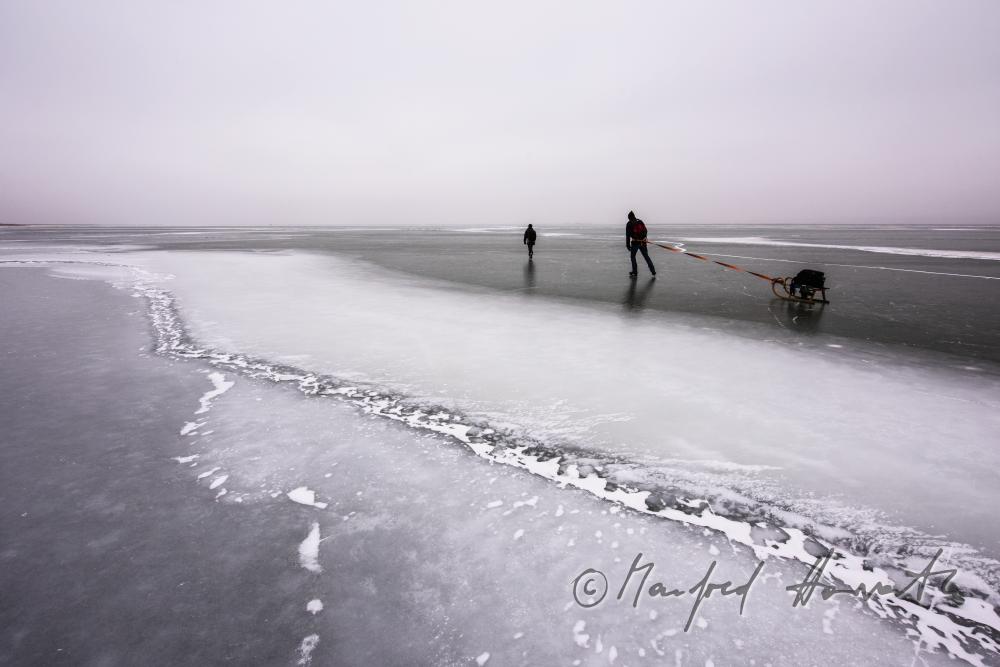 ice skaters with a slade near an ice jam