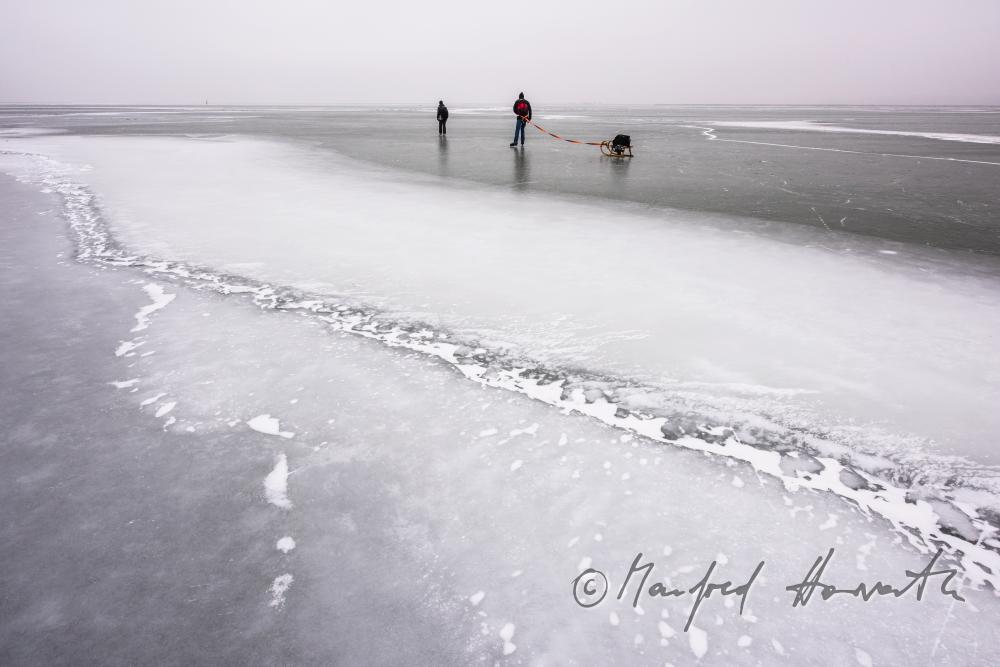 ice skaters with a slade near an ice jam