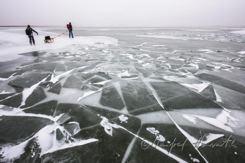 ice skaters with a slade near an ice jam