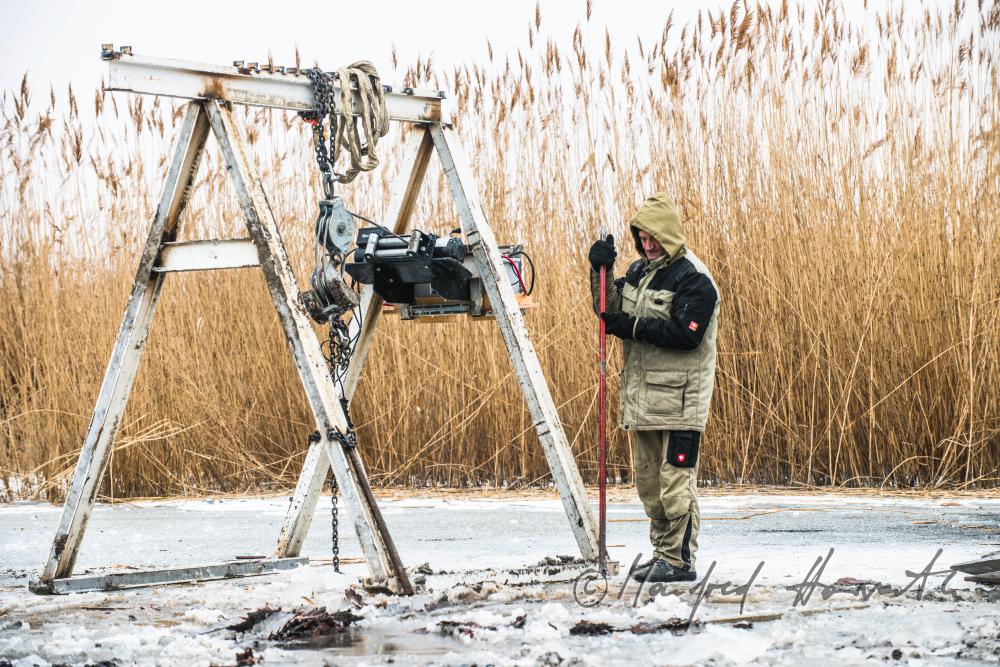 pulling out rotten pickets from the frozen lake