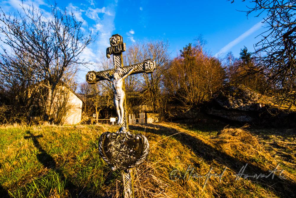 grave cross of a farm house in the middle of nowhere