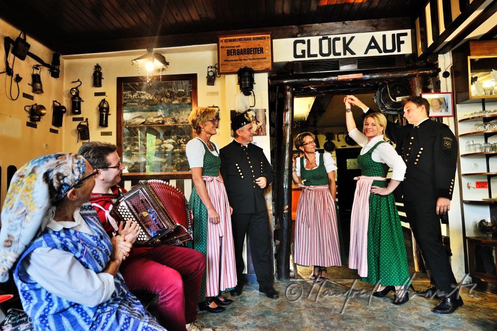 men in miners clothes and women dance in the mining museum